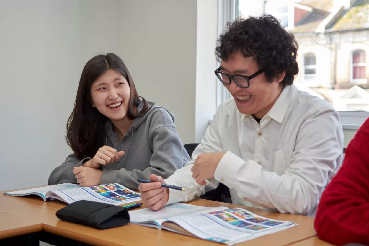 Mina Yang from South Korea laughing with Yoshiki Ukai from Japan whilst on their English study year programme in Brighton.