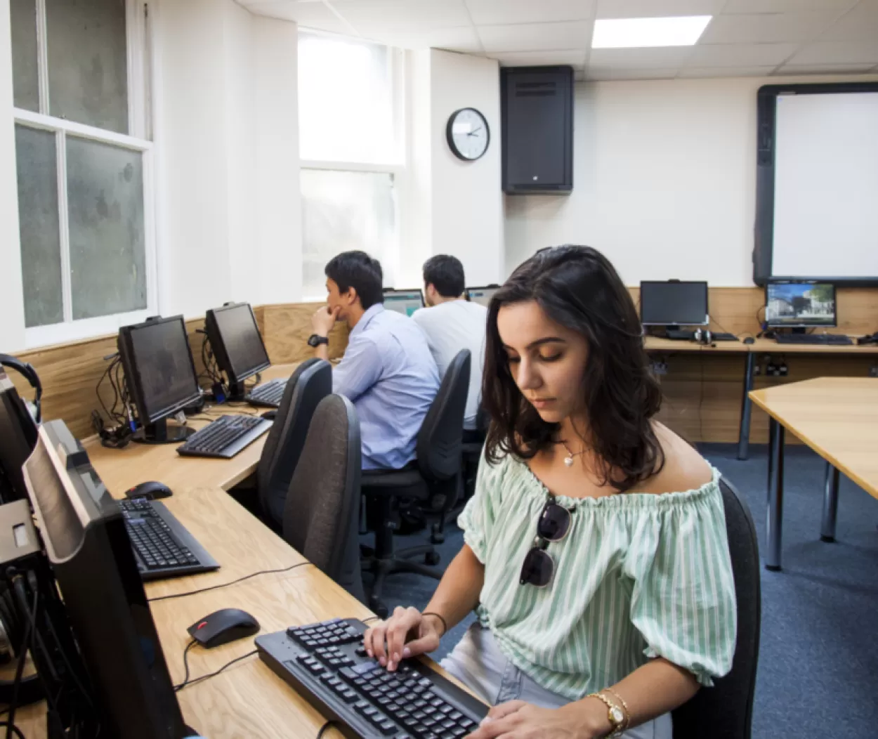 Students concentrate on their work in the computer room at ELC English language school in Brighton, UK.